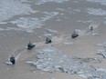 Seal hunting boats sail through the water March 29, 2008 in the Gulf of Saint Lawrence.