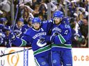 Daniel Sedin gets a hug from twin brother Henrik after scoring in the 2010 Stanley Cup playoffs.