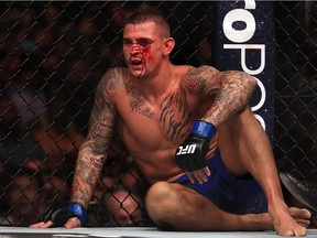 Dustin Poirier sits while fighting Eddie Alvarez in their Lightweight bout during UFC 211 at American Airlines Center on May 13, 2017 in Dallas, Texas.