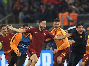 AS Roma's Greek defender Kostas Manolas (C) celebrates after scoring a goal during the UEFA Champions League quarter-final second leg football match between AS Roma and FC Barcelona at the Olympic Stadium in Rome on April 10, 2018.