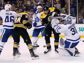 Bruins players swarm around the Maple Leafs net during Game 5 in Boston on Saturday night. (The Associated Press)