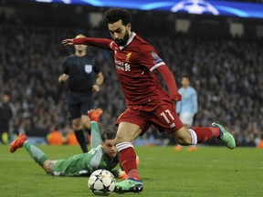 Liverpool's Mohamed Salah scores his side's first goal during the Champions League quarterfinal second leg soccer match between Manchester City and Liverpool at Etihad stadium in Manchester, England, Tuesday, April 10, 2018.