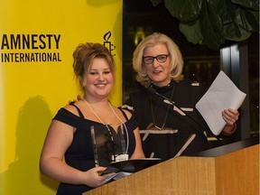 B.C. student Ashley Hyshka receives the Amnesty International Youth Media Award from MC Gillian Findlay.