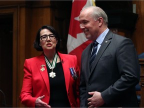 Newly installed Lieutenant-Governor Janet Austin and B.C. Premier John Horgan share a laugh during a ceremony at the Legislature in Victoria on Tuesday April 24.