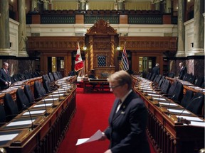 Parliamentary staff ready the legislative assembly for business.