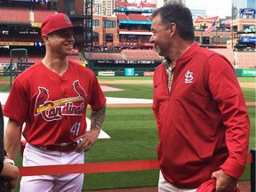 Tyler O'Neill of the St. Louis Cardinals and his former Maple Ridge minor baseball coach Dave Nielsen chat during batting practice at Busch Stadium in St. Louis, Miss.