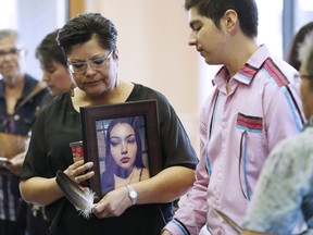Delores Daniels holds a photo of her daughter Serena McKay who was murdered three months ago in Sagkeeng prior to a press conference calling for a re-organization of the National Inquiry into Missing and Murdered Indigenous Women and Girls (MMIWG) in Winnipeg, Wednesday, July 12, 2017. A sentencing hearing is underway for a teenager who pleaded guilty to second-degree murder in a young woman's beating that was captured on video and surfaced online. The body of Serena McKay, who was 19, was found on the Sagkeeng First Nation last April. Two teenage girls, who were 16 and 17, were arrested. The older girl, who has since turned 18 but can't be named because of her age when the beating occurred, pleaded guilty in December.