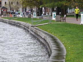 A jogger runs along a path through City Park in Kelowna last May, when high water levels posed a risk of flooding of Okanagan Lake. This is shaping up to be another wait-and-watch spring.