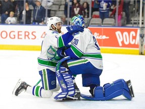 Thatcher Demko and Cam Darcy of the Utica Comets react to losing Game 5 of their AHL series against the Toronto Marlies on Sunday.