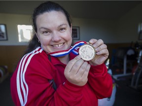 Friends presented Christine Girard with a "gold" medal after the announcement the IOC will award her gold for her performance at the London Olympics after the gold and silver medallists both were stripped of their medals due to steroids.