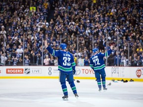 Henrik Sedin and Daniel Sedin wave to the crowd in their final game at Rogers Arena.
