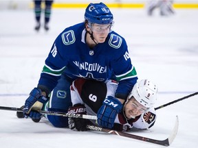 Vancouver Canucks' Jake Virtanen, top, falls on Arizona Coyotes' Clayton Keller during third period NHL hockey action in Vancouver on Thursday, April 5, 2018.