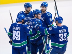 Bo Horvat, surrounded by Vancouver teammates Sam Gagner, Alexander Edler, Daniel Sedin and Henrik Sedin, said it was difficult to hear the twins announce their plans to retire. Horvat hopes the Canucks win their final three games for the "legends."