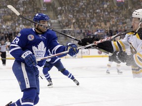 Toronto Maple Leafs centre Nazem Kadri (43) and Boston Bruins defenceman Brandon Carlo (25) high-stick each other earlier this season. Kadri and Brad Marchand are expected to battle in the upcoming opening round playoff series. THE CANADIAN PRESS
