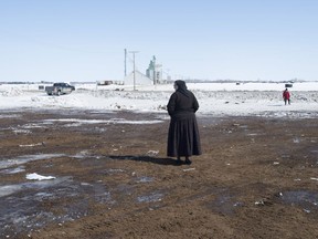 A local resident inspects the intersection of a crash site near Tisdale, Sask., Sunday, April, 8, 2018. A bus carrying the Humboldt Broncos hockey team crashed into a truck en route to Nipawin for a game Friday night killing 15 and sending over a dozen more to the hospital.