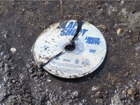A broken DVD of the hockey movie Slap Shot is seen in the mud at the intersection of a crash site near Tisdale, Sask., Sunday, April, 8, 2018. A bus carrying the Humboldt Broncos hockey team crashed into a truck en route to Nipawin for a game Friday night killing 15 and sending over a dozen more to the hospital.
