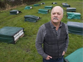 John Gibeau, president of the Honeybee Centre, with commercial hives on a property in Surrey on March 29.
