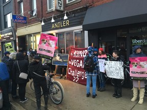 Protesters and police gather outside Antler on Dundas St. W., near Dufferin St., Saturday night.