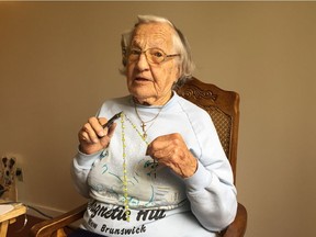Coquitlam’s Beatrice Janyk, holding her rosary beads, says she will be accompanied by her three sons Bill, Bob and Barry when she gives blood yet again on Wednesday.