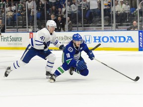 Cole Cassels of the Utica Comets, who scored twice Wednesday in his AHL team's 5-2 playoff victory, is chased by Dmytro Timashov of the Toronto Marlies at the Adirondack Bank Centre. The Comets trail the best-of-five North Division series 2-1. Game 4 is Friday in Utica, N.Y.