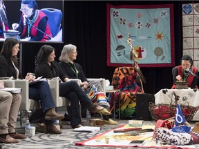 Chief Commissioner Marion Buller, Michele Audette and Qajaq Robinson look on as a ceremonial fire is light during opening ceremony of the National Inquiry of missing and murdered Indigenous women and girls in Richmond, B.C., Wednesday, April, 4, 2018.