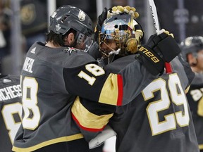 Vegas Golden Knights goaltender Marc-Andre Fleury (29) celebrates with left wing James Neal after the Golden Knights defeated the San Jose Sharks 7-0 in Game 1 of an NHL hockey second-round playoff series Thursday, April 26, 2018, in Las Vegas.