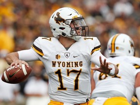 FILE - In this Sept. 2, 2017, file photo, Wyoming quarterback Josh Allen throws a pass during the first half of an NCAA college football game against Iowa, in Iowa City, Iowa. Four quarterbacks are certain to go in the first round of the NFL draft.