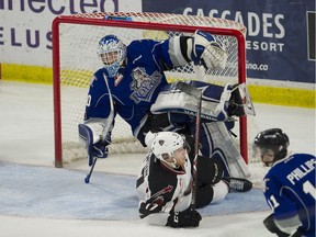 Tyler Benson of the Vancouver Giants slides under Victoria Royals' netminder Griffen Outhouse during Monday's WHL playoff action at Langley Events Centre. Victoria won 4-3 in overtime.