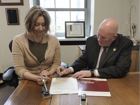 Notary David Watts poses with Adrienne Voute in 2016 for "Make-a-Will Week" in Vancouver.