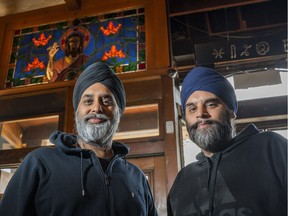 Brothers Harj, left, and Parm Chahl of Benny's Bagels pose for a photo on the last day of their cafe's existence in Vancouver.
