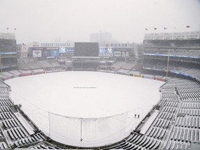 Snow covers the field before the scheduled New York Yankees' home opener game against the Tampa Bay Rays at Yankee Stadium, Monday, April 2, 2018, in New York. The game was postponed due to weather and rescheduled for Tuesday. (AP Photo/Seth Wenig)