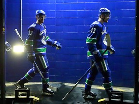 Henrik Sedin and Daniel Sedin walk out to the ice before their NHL game against the Anaheim Ducks at Rogers Arena on March 27, 2018.
