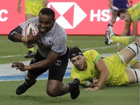 Fiji's Waisea Nacuqu, breaks away to score a try during the HSBC World Rugby Sevens Series 2018 finals on Sunday, April 29, 2018, in Singapore.