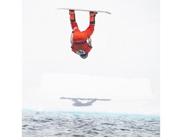 Snowboarder Tomohiro Hatozaki goes for air from a jump into a pool of slush in the Grouse Mountain Slush Cup, North Vancouver  April 21 2018.