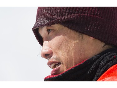 Water drips off Tomohiro Hatozaki's face after he crashed while snowboarding across a pool of slush in the Grouse Mountain Slush Cup, North Vancouver  April 21 2018.