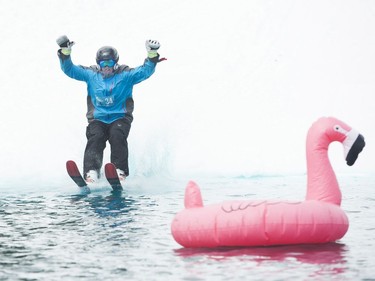 Marko Smitten skis on water during the Grouse Mountain Slush Cup where competitors attempt to cross a pool of slush on their skis or board, North Vancouver  April 21 2018.