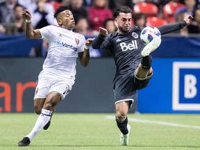 Russell Teibert of the Whitecaps gets his foot on the ball in front of Real Salt Lake's Joao Plata during MLS action at B.C. Place Stadium last season.