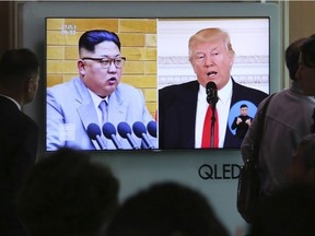 People watch a TV screen showing file footage of U.S. President Donald Trump, right, and North Korean leader Kim Jong Un during a news program at the Seoul Railway Station in Seoul, South Korea, Saturday, April 21, 2018.
