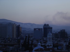 Smoke rises after airstrikes targeting different parts of the Syrian capital Damascus, Syria, early Saturday, April 14, 2018.