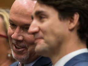 B.C. Premier John Horgan talks with Prime Minister Justin Trudeau at the Women Deliver kickoff event in Vancouver on Nov. 16, 2017.