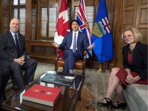 Prime Minister Justin Trudeau, centre, speaks before a meeting about the deadlock over Kinder Morgan's Trans Mountain pipeline expansion with B.C. Premier John Horgan and Alberta Premier Rachel Notley, in Trudeau's on Parliament Hill in Ottawa on April 15.