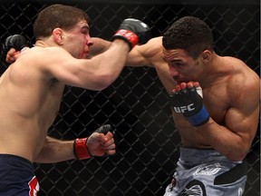 Al Iaquinta, left,  and Kevin Lee exchange blows during the third round of a UFC bout in Newark, N.J. Lee will fight Edson Barboza in Atlantic City on Saturday night in one of the big fights worth watching.