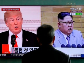 In this March 27, 2018, file photo, a man watches a TV screen showing file footages of U.S. President Donald Trump, left, and North Korean leader Kim Jong Un during a news program at the Seoul Railway Station in Seoul, South Korea.