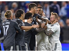 Sporting KC forward Johnny Russell (7) reacts after getting shoved to the ground by Vancouver Whitecaps forward Yordi Reyna (29) during the first half at Children's Mercy Park.