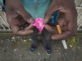 VANDU board member Hugh Lampkin holds $10 worth of heroin in Vancouver, BC. May 5, 2016.