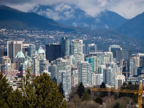 A crane is seen at a condo development under construction as condo and office towers fill the downtown skyline in Vancouver, B.C., on Friday March 30, 2018.