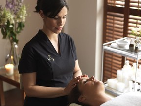 An Aromatherapy Associates practitioner works on a client.