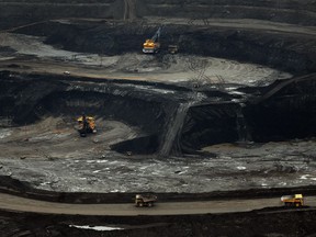 FILE PHOTO - Large excavators load trucks with oil sands at the Suncor mine near the town of Fort McMurray in Alberta Province, Canada on October 23, 2009.