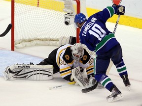 Tim Thomas denies Jeff Tambellini on a scoring chance during Game 7 of 2011 Stanley Cup Final.