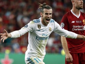 Real Madrid's Gareth Bale celebrates after scoring his side's third goal during the Champions League Final soccer match between Real Madrid and Liverpool at the Olimpiyskiy Stadium in Kiev, Ukraine, Saturday, May 26, 2018. (AP Photo/Pavel Golovkin)